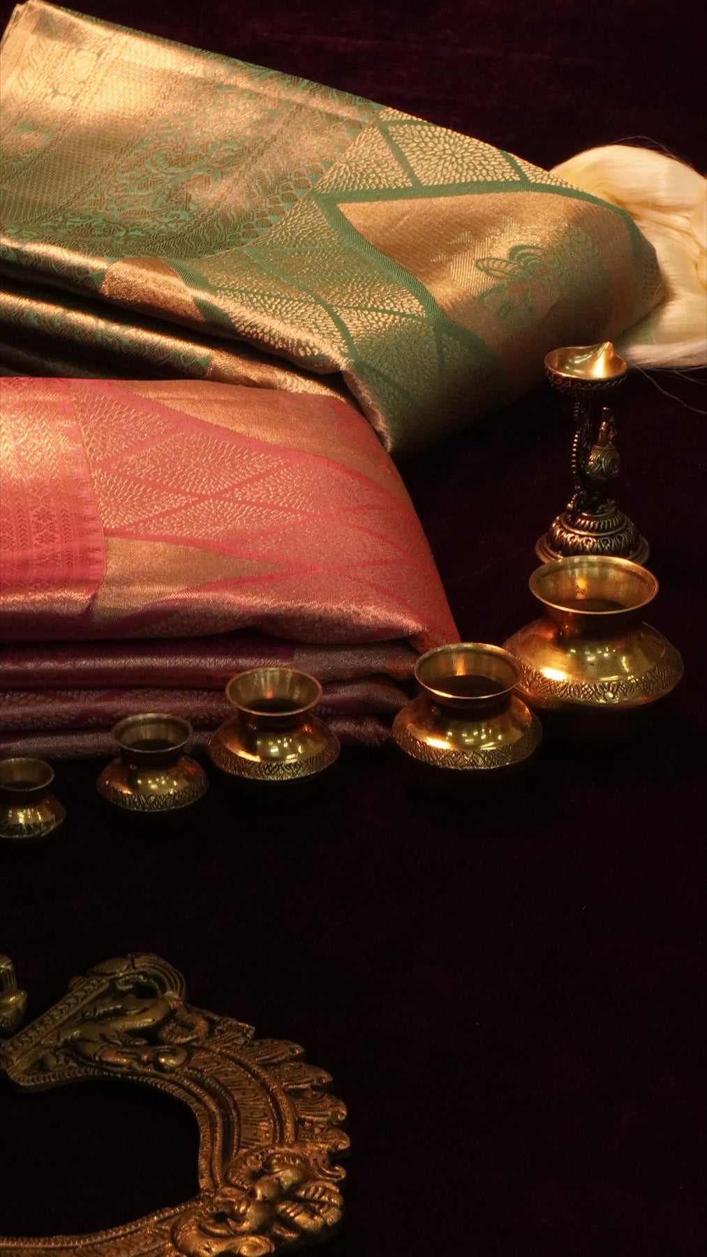 Silk sarees with gold zari and traditional brass ornaments