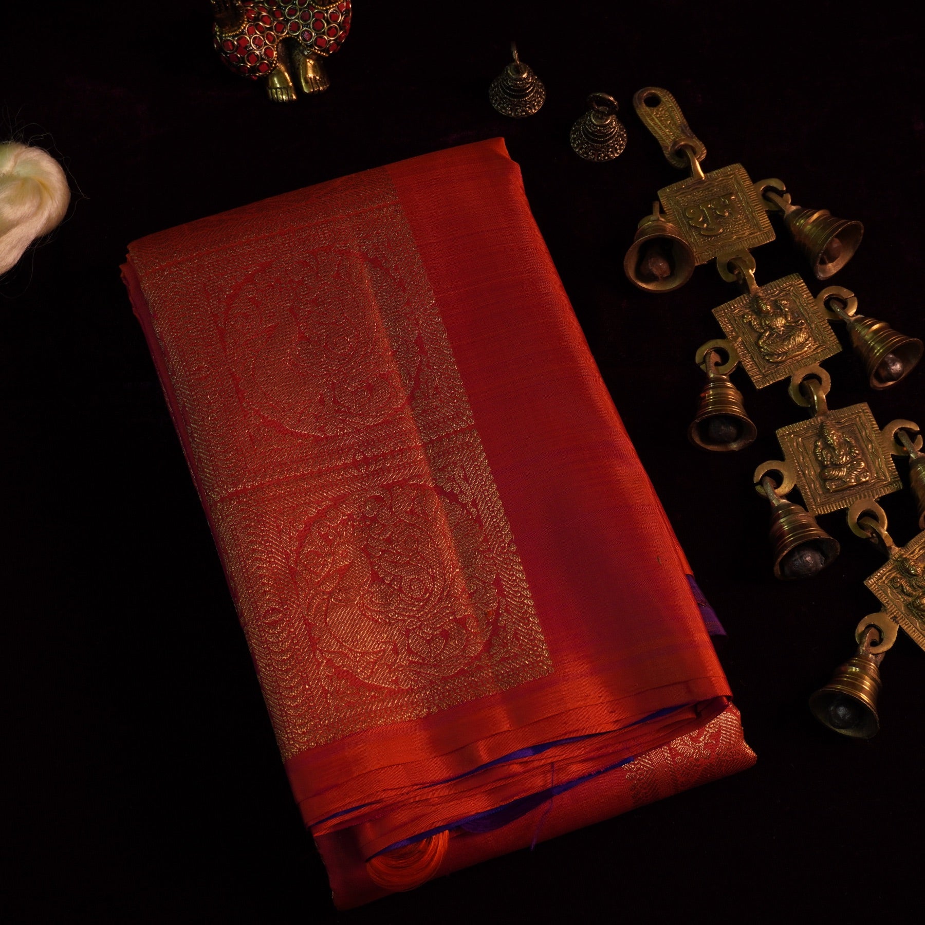 Photo 01 — Folded Saree & Brass Bells (01414)