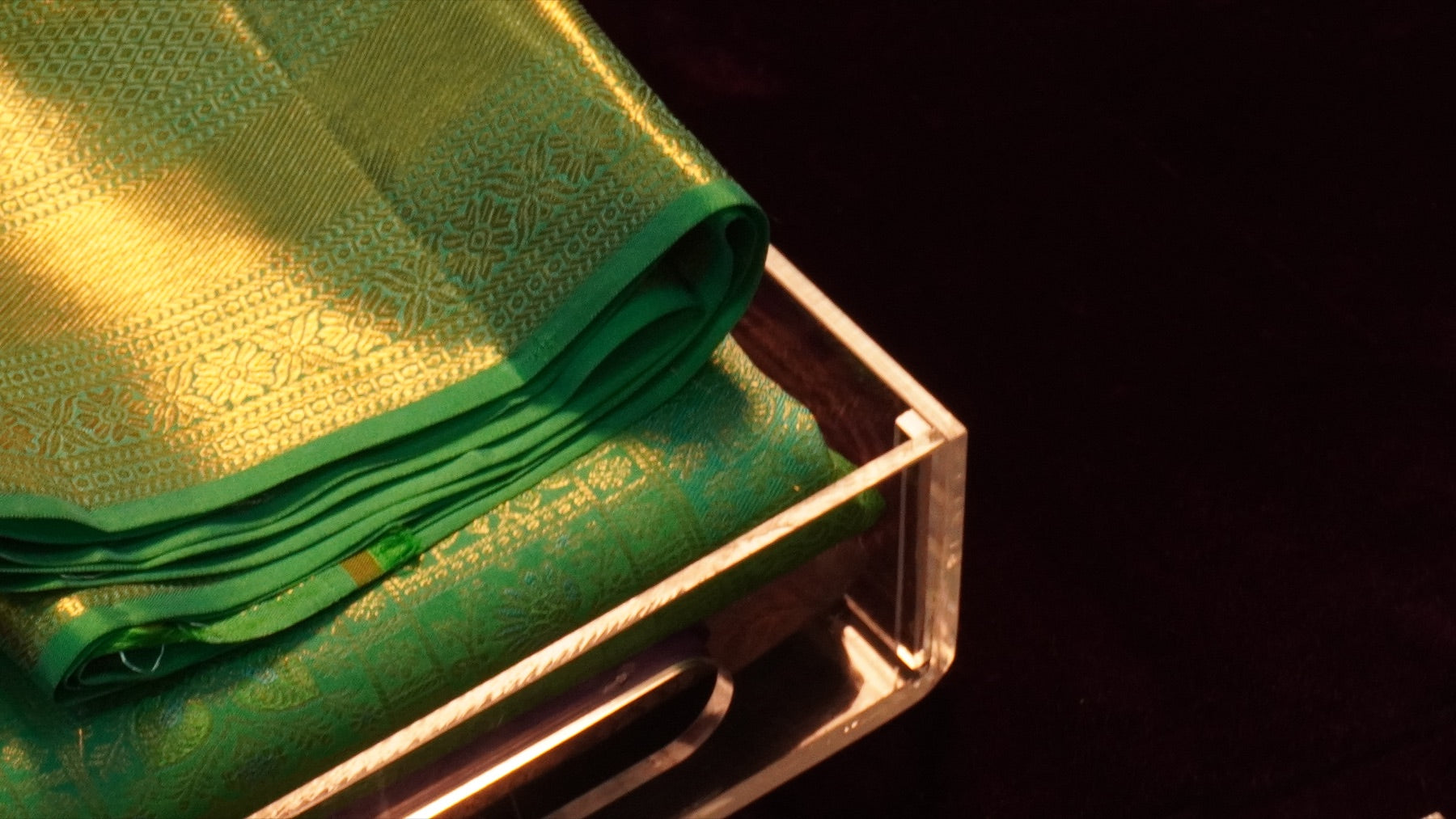 Green silk saree with gold zari in a presentation box
